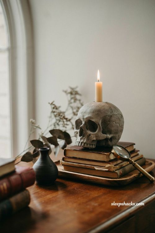 ```text id="j5r8kc" Skull shaped cement candle holder with ivory candle on a stack of worn books, dark academia reading nook, aged wooden tray, antique brass accents, dried botanical stems, deep walnut furniture, weathered stone texture, soft window light, warm candle glow, sophisticated gothic Halloween decor, vintage study atmosphere, moody timeless styling, photorealistic editorial interior photography, Pinterest-worthy ``` 