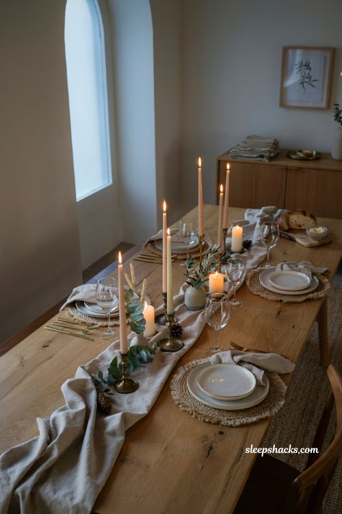 varied height candles modern Thanksgiving table with warm elegant holiday decor