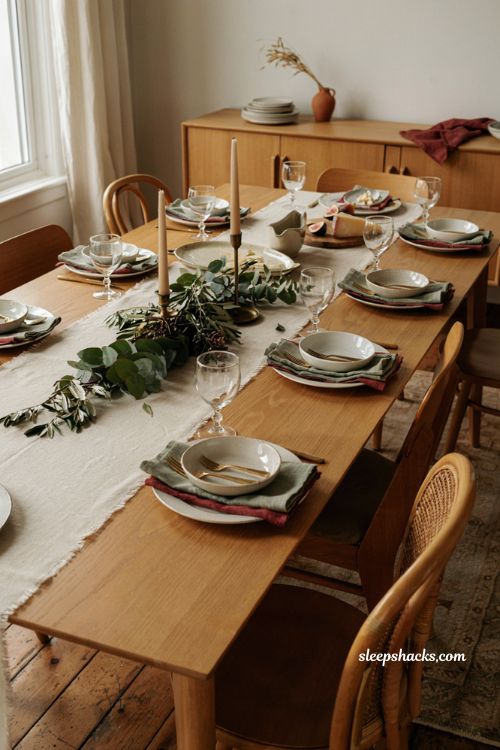 white dinnerware Thanksgiving table with sage napkins greenery and timeless holiday decor