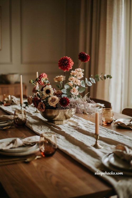 Asymmetrical Thanksgiving floral centerpiece with dahlias roses eucalyptus and golden vase 
