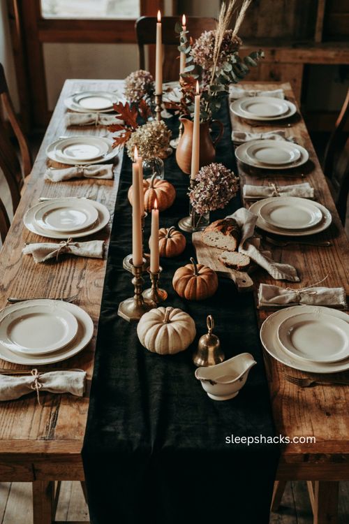 Black Thanksgiving table runner with cream dishes gold flatware and autumn decor 