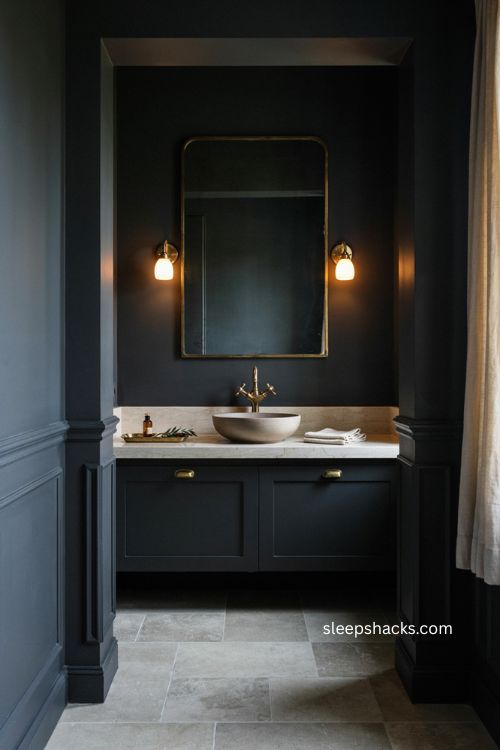 Black bathroom with warm brass fixtures ivory accents and reflective mirror