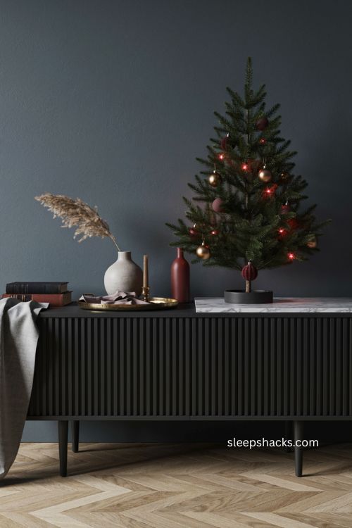 Black mini Christmas tree with purple and deep red lights on console