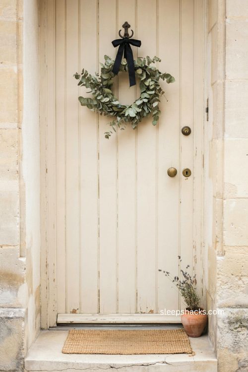 Black ribbon on eucalyptus wreath for minimalist Halloween front door decor
