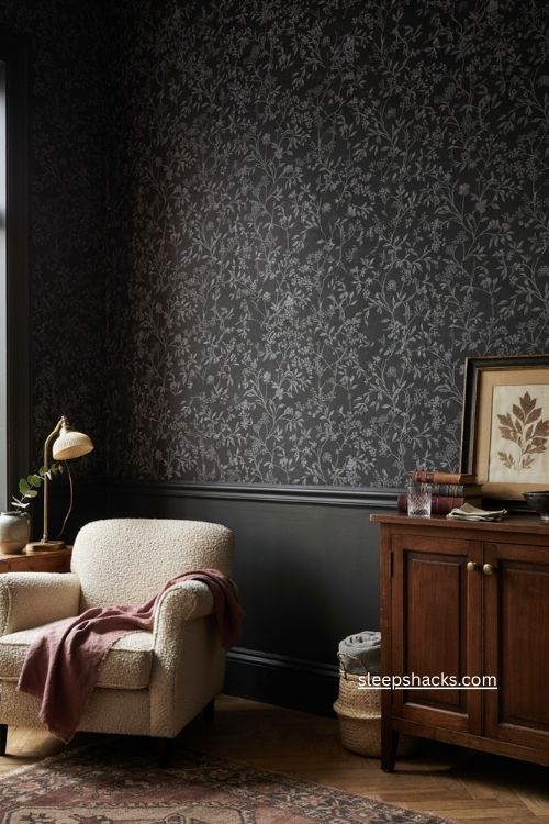 Black wallpaper reading corner with botanical pattern vintage chair brass lamp and cozy decor 