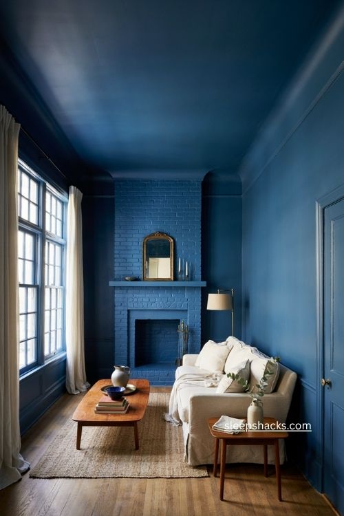 Blue color drenched living room with matching walls trim ceiling and fireplace 