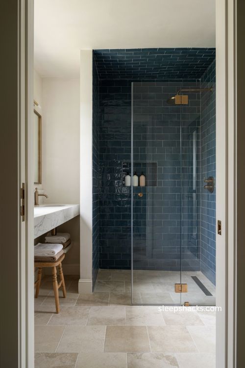 Blue subway tile shower with tiled ceiling built in niche and classic bathroom details 