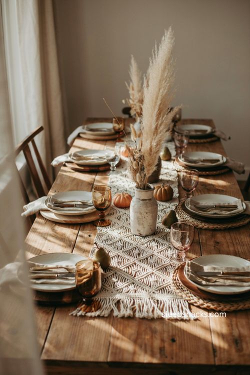 Boho thanksgiving table with dried pampas grass and airy natural centerpiece