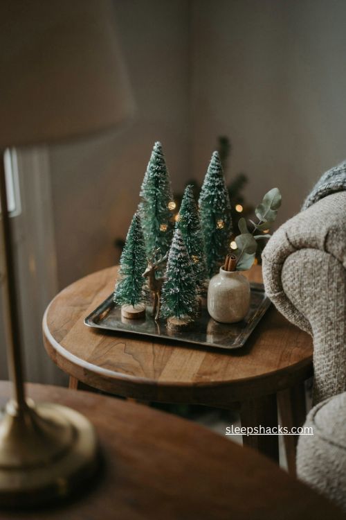 Bottlebrush tree christmas end table decor with tiny reindeer and snowy village 