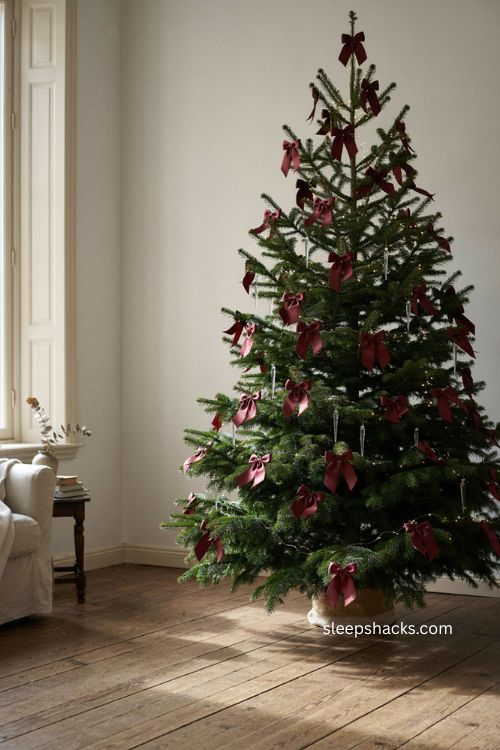 Cascading burgundy velvet ribbon Christmas tree with oversized bow 
