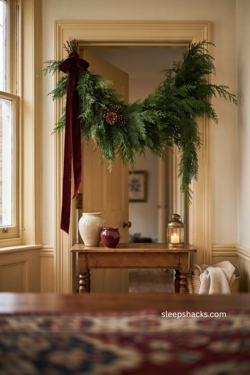 Cedar and velvet Christmas swag with burgundy ribbon and natural pinecones