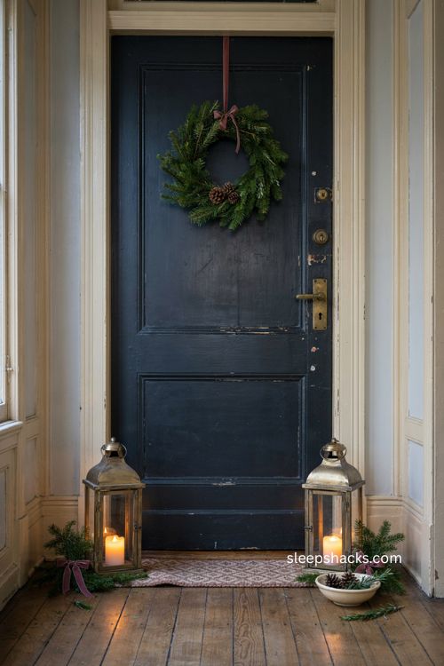 Christmas apartment door decor with matching lanterns evergreen wreath and cozy led candlelight 
