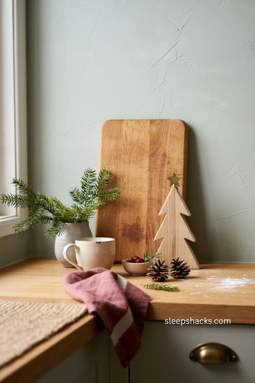 Christmas cutting board leaned against backsplash with a cozy holiday kitchen vignette 