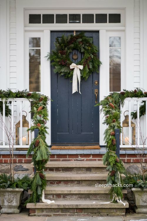Christmas door swag with matching stair railing greenery and ribbon decor