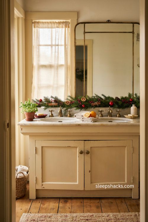 Christmas garland over bathroom sink with citrus cinnamon and red accents