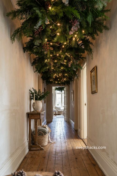 Christmas greenery canopy with lights in hallway ceiling 