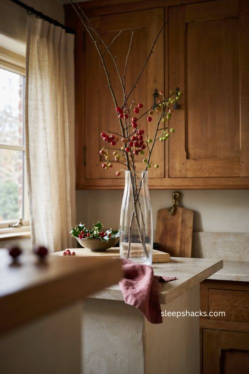 Christmas kitchen island decor with tall vase and berry branches