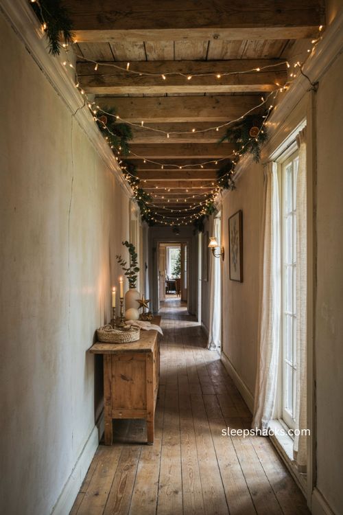 Christmas lights wrapped along exposed hallway ceiling beams 