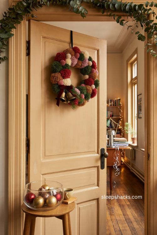 Christmas office door decorating ideas with pom pom wreath bells and festive entryway decor