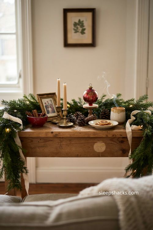 Christmas sofa table decor with personal heirlooms family photo and cozy garland