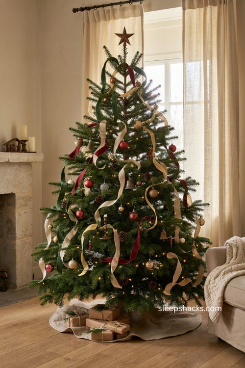 Christmas tree ribbon ideas with layered ribbon and warm ornaments