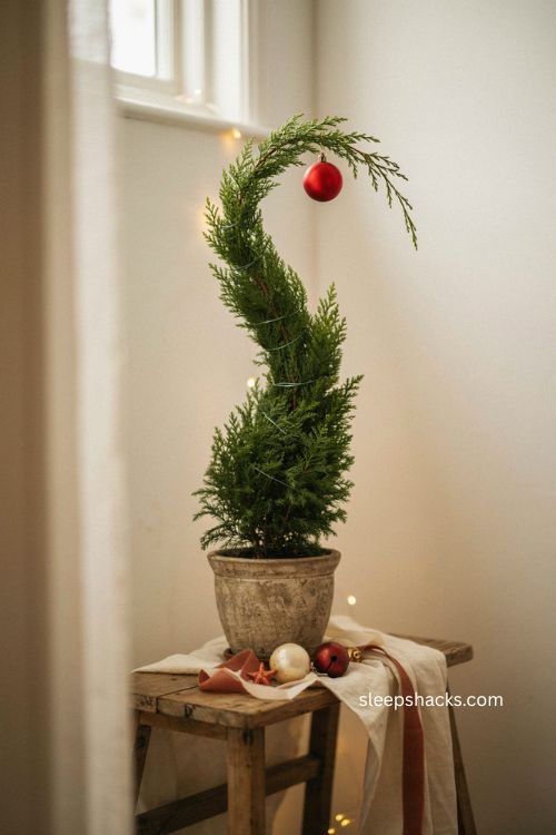 Classic bent lemon cypress grinch tree with red ornament and green wire