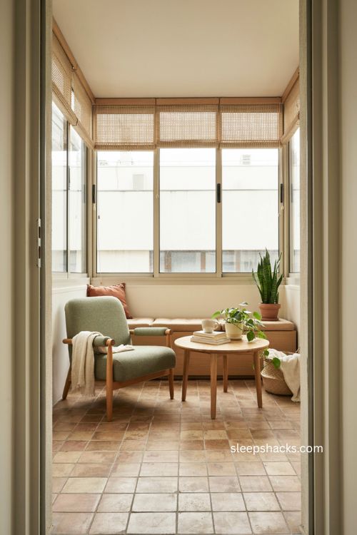 Closed balcony ideas with cozy sunroom seating and glass enclosure