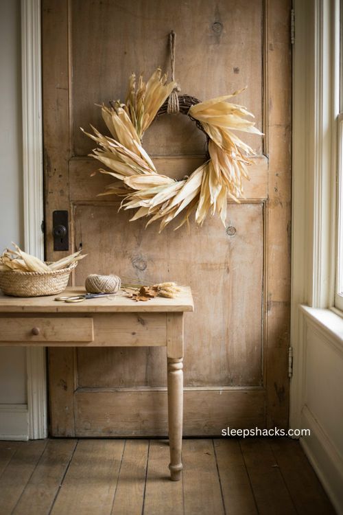 Corn husk wreath Thanksgiving door decor with layered dried husks and rustic farmhouse texture 