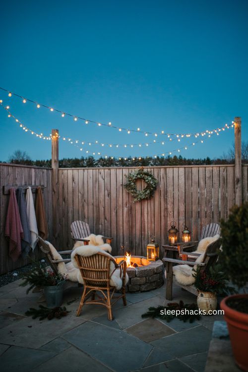 Cozy Christmas fire pit area with sheepskin throws blankets string lights and lanterns