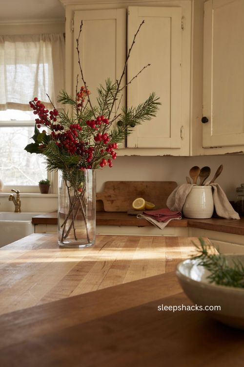 Cozy Christmas kitchen with berry branches in a tall glass vase