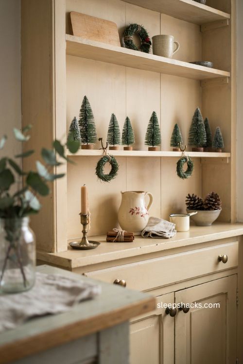 Cozy Christmas kitchen with mini trees and vintage open shelf decor