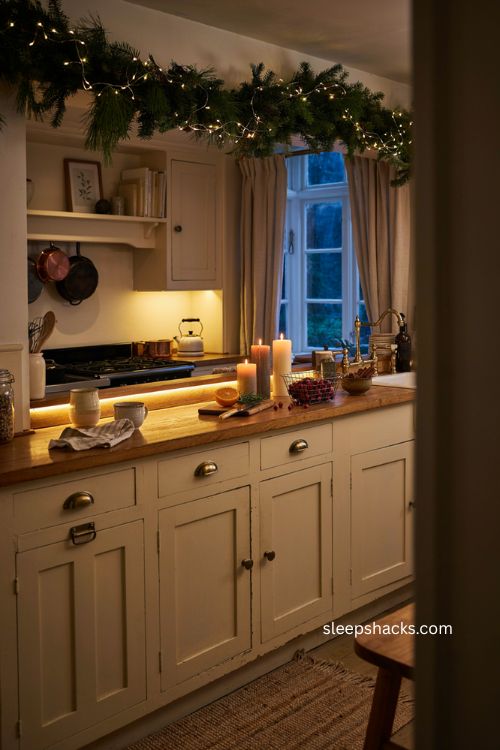 Cozy Christmas kitchen with warm accent lighting and glowing garland 