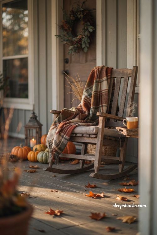 Cozy Thanksgiving porch chair with plaid throw blanket pumpkins mums and warm autumn decor