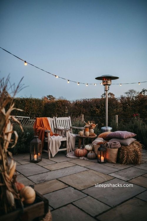 Cozy backyard Halloween seating with blankets hay bales patio heater and warm drinks 