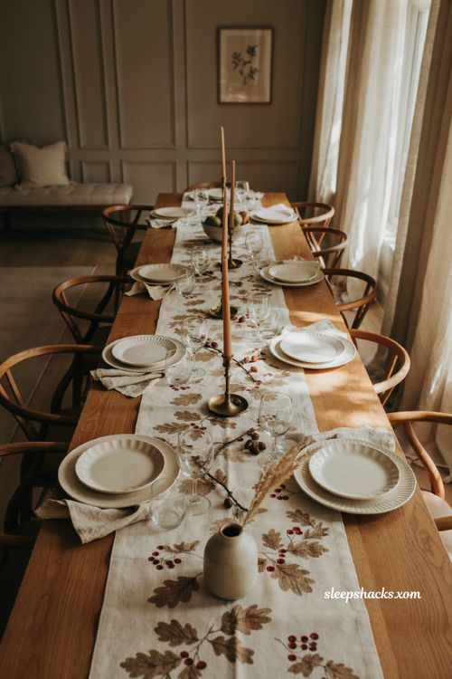 Cream botanical Thanksgiving table runner with oak leaves acorns and dark red berries
