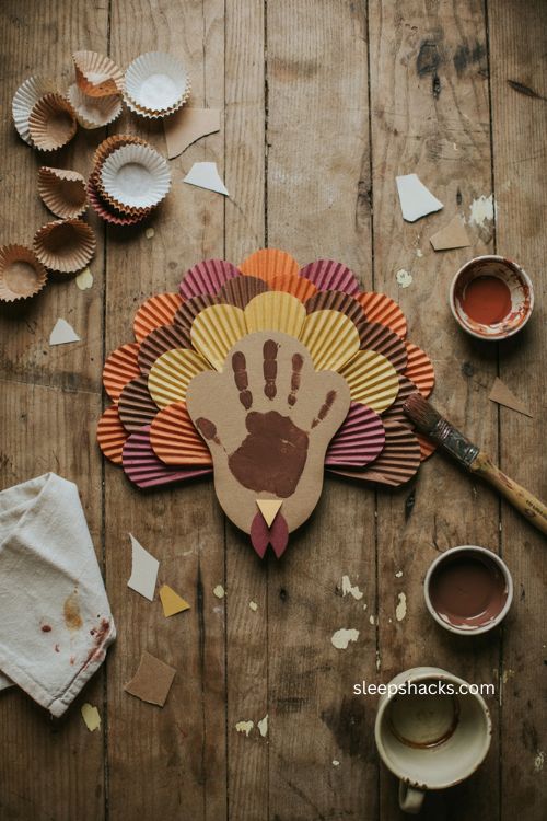Cupcake liner turkey craft with baby handprint for Thanksgiving 