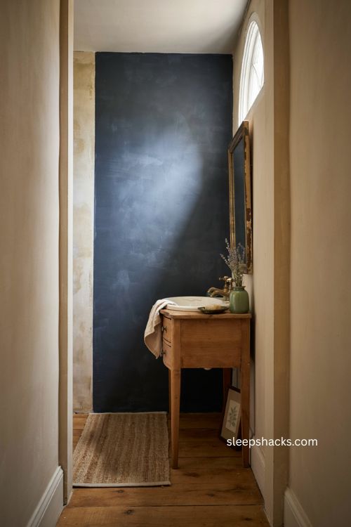 Dark accent wall bathroom with light walls vintage vanity and cozy powder room 