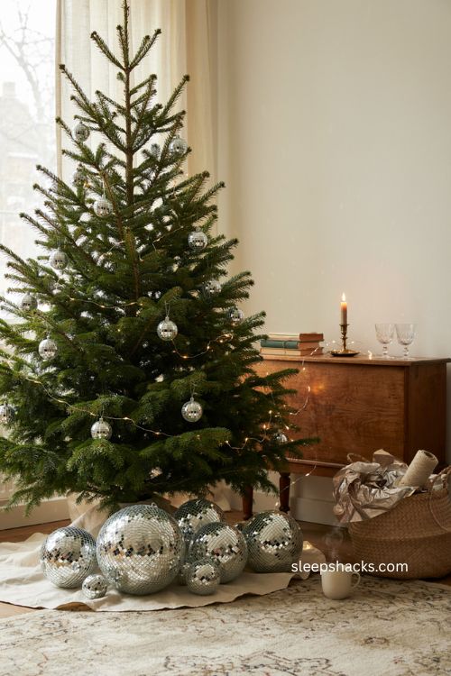 Disco ball Christmas tree with mirrored ornaments warm lights and retro holiday decor