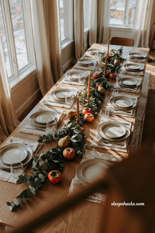 Dried eucalyptus and fall fruit Thanksgiving centerpiece with apples pears and persimmons 