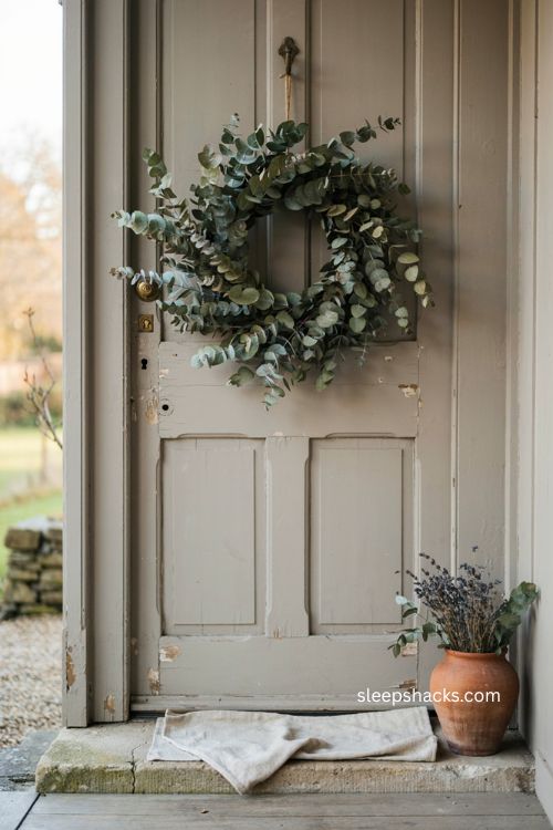 Dried eucalyptus wreath on front door for minimalist Halloween decor