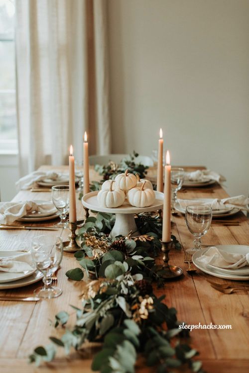 Elegant Thanksgiving tablescape with white pumpkins gold accents and natural garland