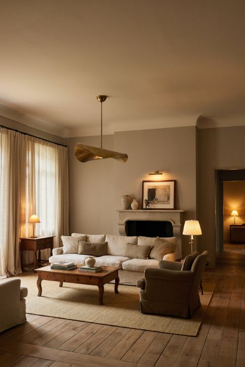 Elegant living room decor with sculptural lighting oversized pendant and vintage floor lamp 