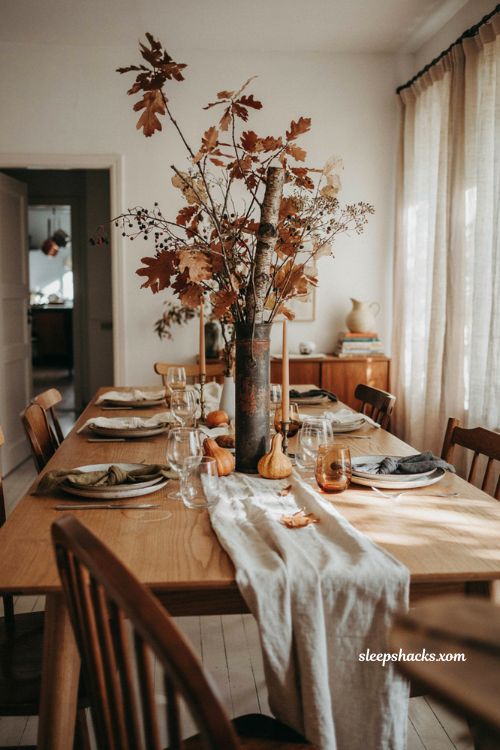 Everyday object repurposed Thanksgiving centerpiece with fall branches in an umbrella stand 
