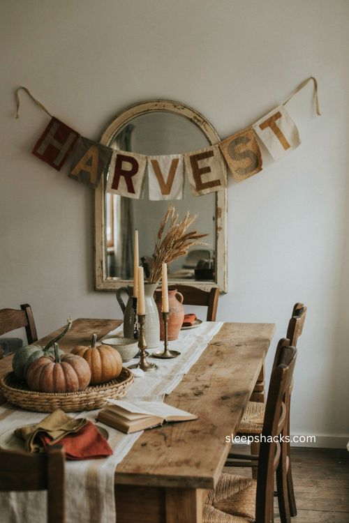 Fabric harvest banner in rust olive and cream over a vintage Thanksgiving dining room mirror
