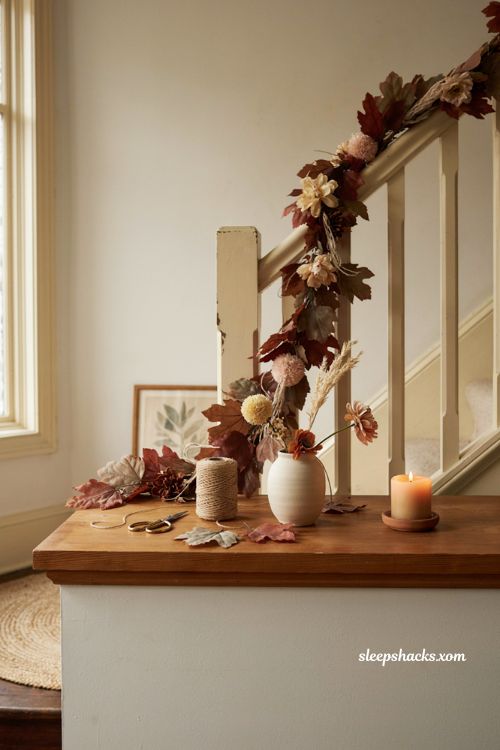 Fall floral garland decor with cozy yarn flowers and autumn leaves on mantel 