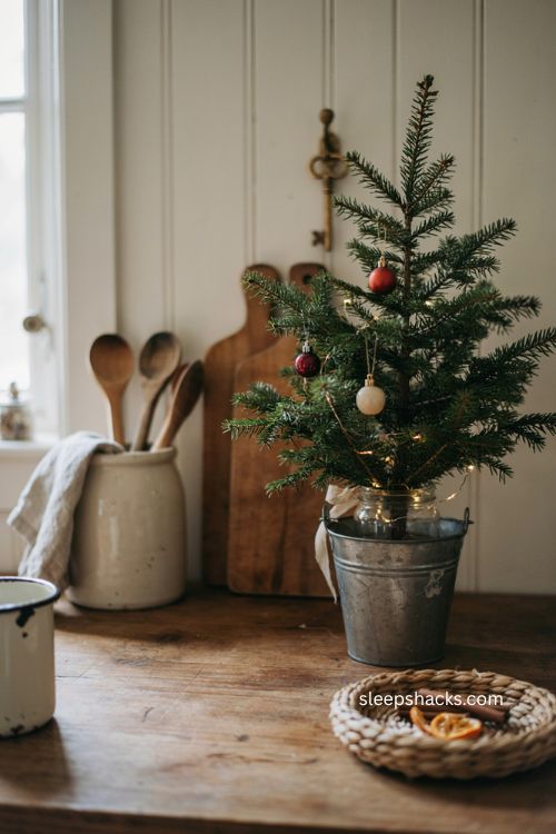 Farmhouse Christmas kitchen with a small tree in a vintage galvanized bucket