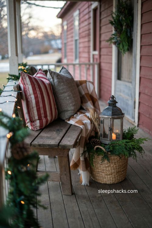 Farmhouse Christmas porch with red grain sack pillows and plaid 