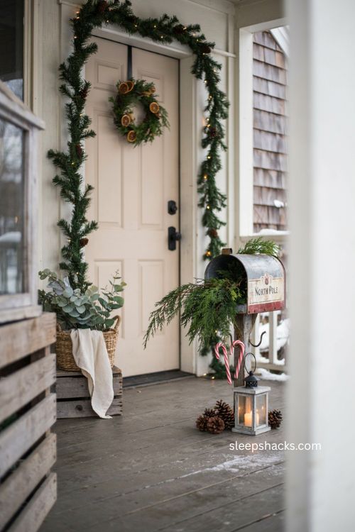 Farmhouse Christmas porch with seasonal mailbox and greenery 