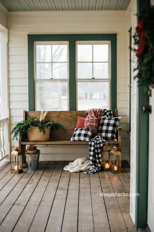 Farmhouse Christmas porch with vintage church pew and plaid pillows 