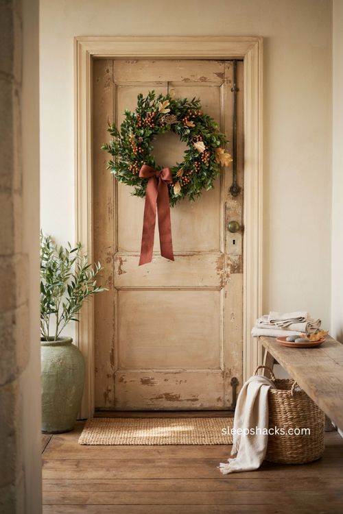 Faux boxwood fall thanksgiving wreath with orange accents and deep rust bow 